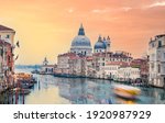 Stunning view of the Venice skyline with the Grand Canal and Basilica Santa Maria Della Salute in the distance during a dramatic sunrise. Picture taken from Ponte Dell’ Accademia.