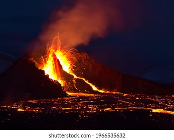 Stunning view of volcanic eruption in Geldingadalir valley near Fagradalsfjall mountain, Grindavík, Reykjanes peninsula, southwest Iceland with long exposure of lava ejection at night. - Shutterstock ID 1966535632