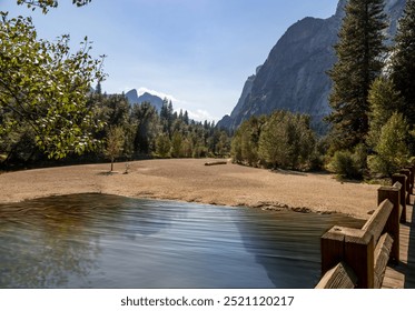 Stunning view of Yosemite Valley from the Swinging Bridge trail, showcasing towering granite cliffs, lush forests, and a serene river. A perfect blend of natural beauty and tranquility. - Powered by Shutterstock