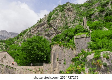 Stunning views of Kotor, Montenegro's historic coastal town, featuring medieval architecture, picturesque seashore, and majestic mountains. Perfect for travel, tourism, and nature photography  - Powered by Shutterstock