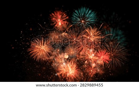 A stunning visual of numerous fireworks bursting in the dark sky, creating a spectacular celebration of light and color.