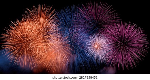 A stunning visual spectacle of multiple fireworks bursting in the dark night sky, creating a dazzling array of colors and patterns.