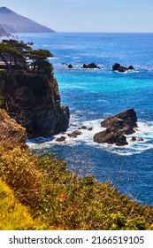 Stunning West Coast Ocean View With Rocky Cliffs And Vibrant Blue Water