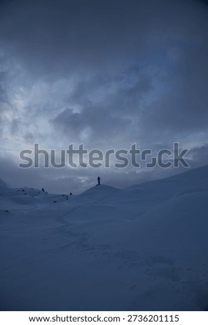 Stunning wintry landscape with dramatic clouds and snow-covered terrain.