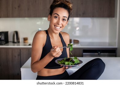 Stunning Woman Eating Salad In Morning. Woman In Sportive Clothes Getting Ready For New Day. Home, Morning Routine, Food Concept