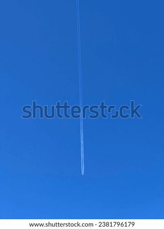 A stunningly clear blue sky with white airplane contrails crisscrossing the sky, creating an impressive visual effect