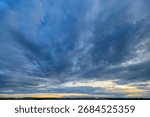 A stunningly dramatic sky filled with clouds during the beautiful dusk time of day
