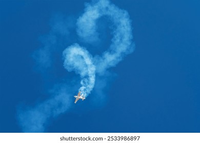 Stunt aerobatic plane performing stunts rolls loops in blue sky with smoke trail. Concept of speed, difficulty, precision, risk, challenge - Powered by Shutterstock