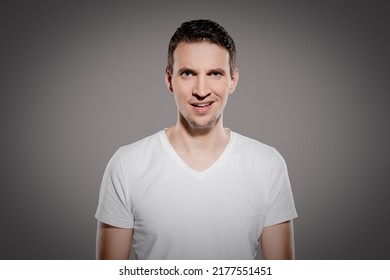 stupid and mindless face expression of man while look at camera and show his questioning  emotions with eyes and glimpse at camera isolated on gray background - Shutterstock ID 2177551451