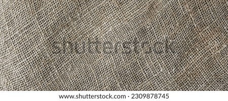 Sturdy rough sackcloth textured background panoramic view. Burlap detail backdrop.