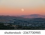 The Sturgeon moon was spotted rising as the last light of the sun illuminates the hills behind in a golden light