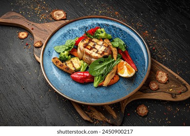 Sturgeon steak with roasted vegetables. Menu for a pub on a dark background. Colorful juicy food photography. - Powered by Shutterstock