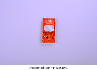 Sturtevant, Wisconsin / USA - August 20, 2019:  One Single Taco Bell Hot Sauce Packet Centered And Isolated On A White Background. 