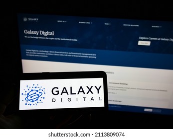 Stuttgart, Germany - 01-22-2022: Person Holding Smartphone With Logo Of US Company Galaxy Digital Holdings Ltd. On Screen In Front Of Website. Focus On Phone Display. Unmodified Photo.