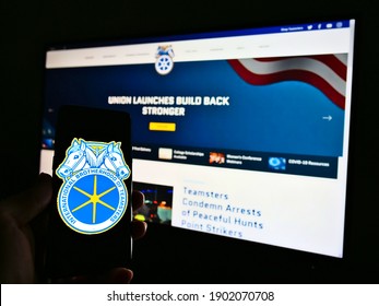 Stuttgart, Germany - 01-23-2021: Person Holding Smartphone With Logo Of Labor Union International Brotherhood Of Teamsters On Screen. Focus On Center Of Mobile Phone Screen. Unmodified Photo.