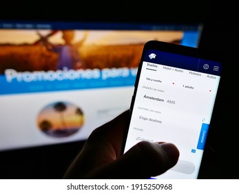 Stuttgart, Germany - 01-31-2021: Person Booking Flight On Website Of Airline Aerovías De México (Aeroméxico) On Smartphone In Front Of Screen. Focus On Top Of Cell Phone Display. Unmodified Photo.