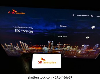 Stuttgart, Germany - 01-31-2021: Person Holding Smartphone With Logo Of South Korean Oil And Gas Company SK Innovation On Screen In Front Of Website. Focus On Phone Display. Unmodified Photo.