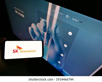 Stuttgart, Germany - 01-31-2021: Person Holding Mobile Phone With Logo Of South Korean Oil And Gas Company SK Innovation On Screen In Front Of Web Page. Focus On Cellphone Display. Unmodified Photo.