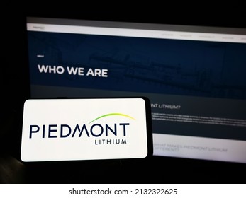 Stuttgart, Germany - 02-26-2022: Person holding cellphone with logo of US mining company Piedmont Lithium Inc. on screen in front of business webpage. Focus on phone display. Unmodified photo.