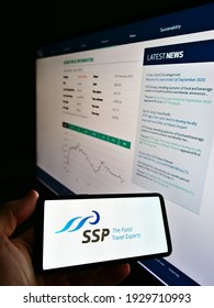Stuttgart, Germany - 02-27-2021: Person Holding Mobile Phone With Logo Of British Foodservice Company SSP Group Plc On Screen In Front Of Web Page With Chart. Focus On Phone Display. Unmodified Photo.