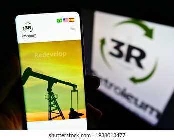 Stuttgart, Germany - 02-28-2021: Person holding cellphone with web page of Brazilian oil and gas company 3R Petroleum SA on screen in front of logo. Focus on center of phone display. Unmodified photo.