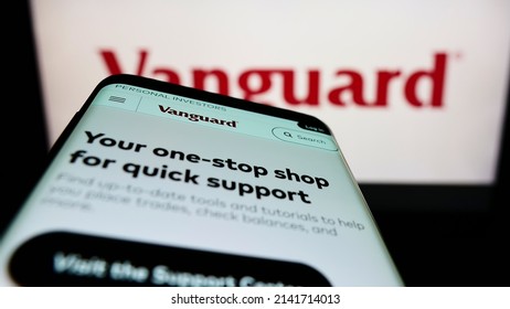 Stuttgart, Germany - 03-12-2022: Mobile phone with website of American financial company The Vanguard Group Inc. on screen in front of logo. Focus on top-left of phone display. Unmodified photo.