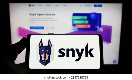 Stuttgart, Germany - 03-12-2022: Person Holding Mobile Phone With Logo Of American Cybersecurity Company Snyk Limited On Screen In Front Of Web Page. Focus On Phone Display. Unmodified Photo.