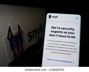 Stuttgart, Germany - 03-12-2022: Person Holding Cellphone With Webpage Of US Cybersecurity Company Snyk Limited On Screen In Front Of Logo. Focus On Center Of Phone Display. Unmodified Photo.