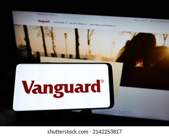 Stuttgart, Germany - 03-12-2022: Person holding cellphone with logo of US financial company The Vanguard Group Inc. on screen in front of business web page. Focus on phone display. Unmodified photo.
