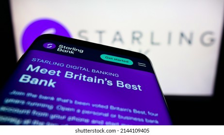 Stuttgart, Germany - 03-30-2022: Mobile Phone With Website Of British Challenger Bank Starling Bank Limited On Screen In Front Of Logo. Focus On Top-left Of Phone Display. Unmodified Photo.