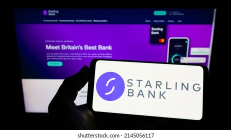 Stuttgart, Germany - 03-30-2022: Person Holding Mobile Phone With Logo Of British Challenger Bank Starling Bank Ltd. On Screen In Front Of Web Page. Focus On Phone Display. Unmodified Photo.