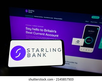 Stuttgart, Germany - 03-30-2022: Person Holding Cellphone With Logo Of British Challenger Bank Starling Bank Ltd. On Screen In Front Of Business Webpage. Focus On Phone Display. Unmodified Photo.