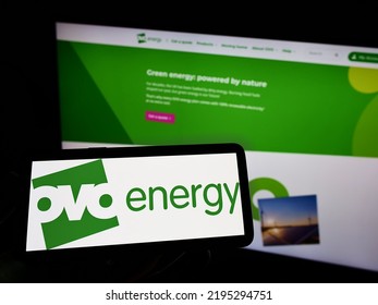 Stuttgart, Germany - 03-30-2022: Person Holding Cellphone With Logo Of British Utility Company OVO Energy Ltd On Screen In Front Of Business Webpage. Focus On Phone Display. Unmodified Photo.