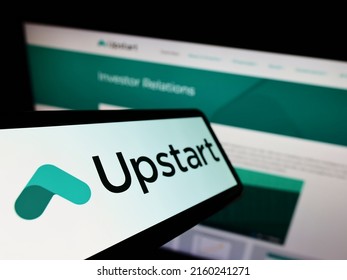 Stuttgart, Germany - 05-15-2022: Cellphone with logo of American fintech company Upstart Network Inc. on screen in front of website. Focus on center-left of phone display. Unmodified photo.