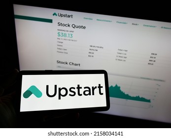 Stuttgart, Germany - 05-15-2022: Person holding mobile phone with logo of American fintech company Upstart Network Inc. on screen in front of web page. Focus on phone display. Unmodified photo.