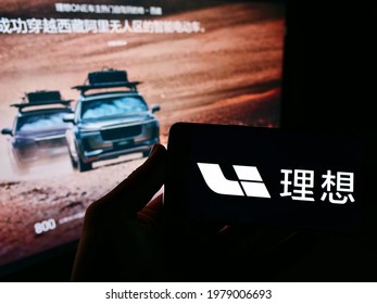 Stuttgart, Germany - 05-21-2021: Person Holding Mobile Phone With Logo Of Chinese Electric Car Manufacturer Li Auto Inc On Screen In Front Of Web Page. Focus On Cellphone Display. Unmodified Photo.