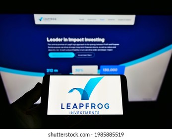 Stuttgart, Germany - 05-21-2021: Person holding mobile phone with business logo of private equity firm LeapFrog Investments on screen in front of web page. Focus on phone display. Unmodified photo.