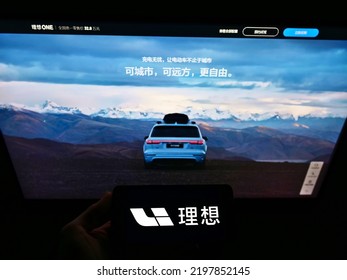 Stuttgart, Germany - 05-21-2021: Person Holding Smartphone With Logo Of Chinese Electric Car Producer Li Auto Inc. On Screen In Front Of Business Web Page. Focus On Phone Display. Unmodified Photo.