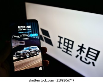 Stuttgart, Germany - 05-21-2021: Person Holding Smartphone With Web Page Of Chinese Electric Car Manufacturer Li Auto Inc On Screen With Logo. Focus On Center Of Phone Display. Unmodified Photo.