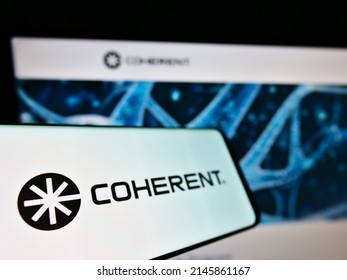 Stuttgart, Germany - 05-21-2021: Smartphone with business logo of American laser manufacturer Coherent Inc. on screen in front of website. Focus on center-left of phone display. Unmodified photo.