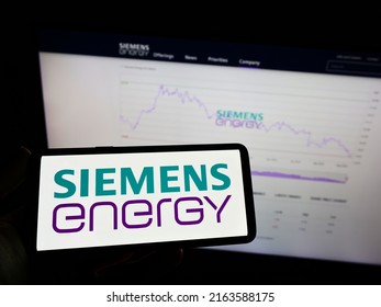Stuttgart, Germany - 05-21-2022: Person Holding Mobile Phone With Logo Of German Technology Company Siemens Energy AG On Screen In Front Of Web Page. Focus On Phone Display. Unmodified Photo.