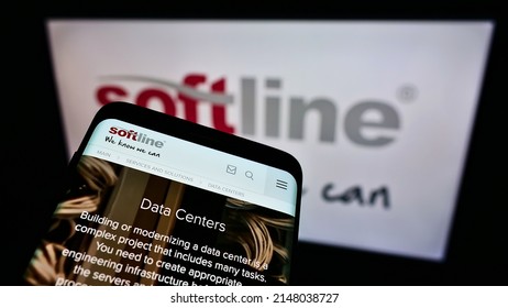 Stuttgart, Germany - 05-23-2021: Mobile Phone With Website Of Global IT Solutions Provider Softline International On Screen In Front Of Logo. Focus On Top-left Of Phone Display. Unmodified Photo.