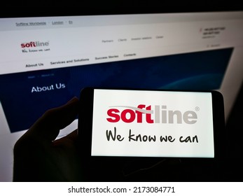 Stuttgart, Germany - 05-23-2021: Person Holding Cellphone With Logo Of Global IT Solutions Provider Softline International On Screen In Front Of Webpage. Focus On Phone Display. Unmodified Photo.