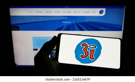 Stuttgart, Germany - 05-29-2022: Person Holding Smartphone With Logo Of British Investment Company 3i Group Plc On Screen In Front Of Website. Focus On Phone Display. Unmodified Photo.