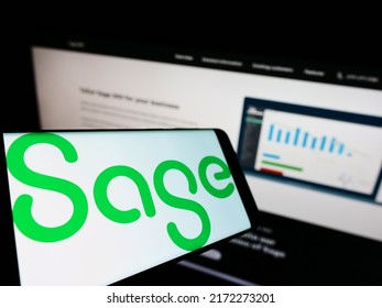 Stuttgart, Germany - 05-29-2022: Smartphone with logo of British software company The Sage Group plc on screen in front of business website. Focus on center-left of phone display. Unmodified photo.