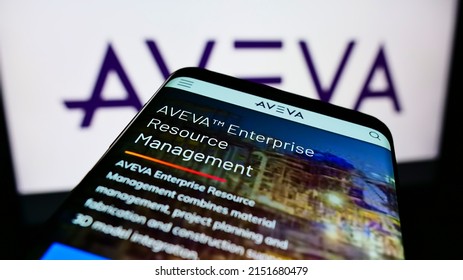 Stuttgart, Germany - 06-06-2021: Cellpohone with webpage of British software company AVEVA Group plc on screen in front of business logo. Focus on top-left of phone display. Unmodified photo.