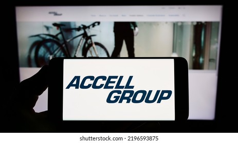 Stuttgart, Germany - 06-10-2022: Person Holding Smartphone With Logo Of Dutch Bicycle Company Accell Group N.V. On Screen In Front Of Website. Focus On Phone Display. Unmodified Photo.