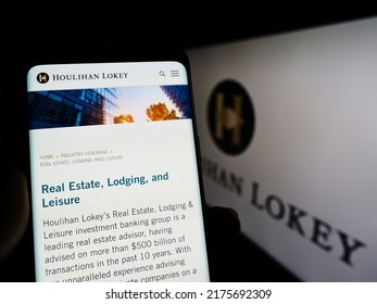 Stuttgart, Germany - 06-12-2022: Person Holding Smartphone With Website Of US Investment Company Houlihan Lokey Inc. On Screen In Front Of Logo. Focus On Center Of Phone Display. Unmodified Photo.