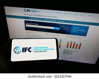 Stuttgart, Germany - 06-13-2021: Person Holding Cellphone With Logo Of Development Bank International Finance Corporation (IFC) On Screen In Front Of Webpage. Focus On Phone Display. Unmodified Photo.