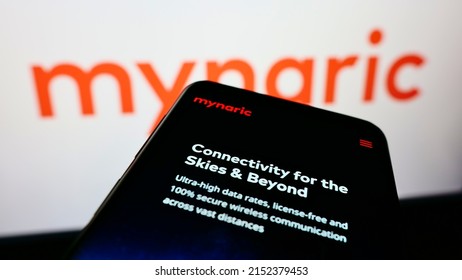 Stuttgart, Germany - 06-18-2021: Person Holding Cellphone With Website Of German Laser Equipment Manufacturer Mynaric AG On Screen With Logo. Focus On Top-left Of Phone Display. Unmodified Photo.